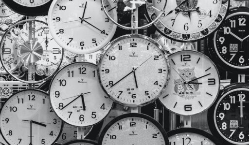 black and white photo of clocks